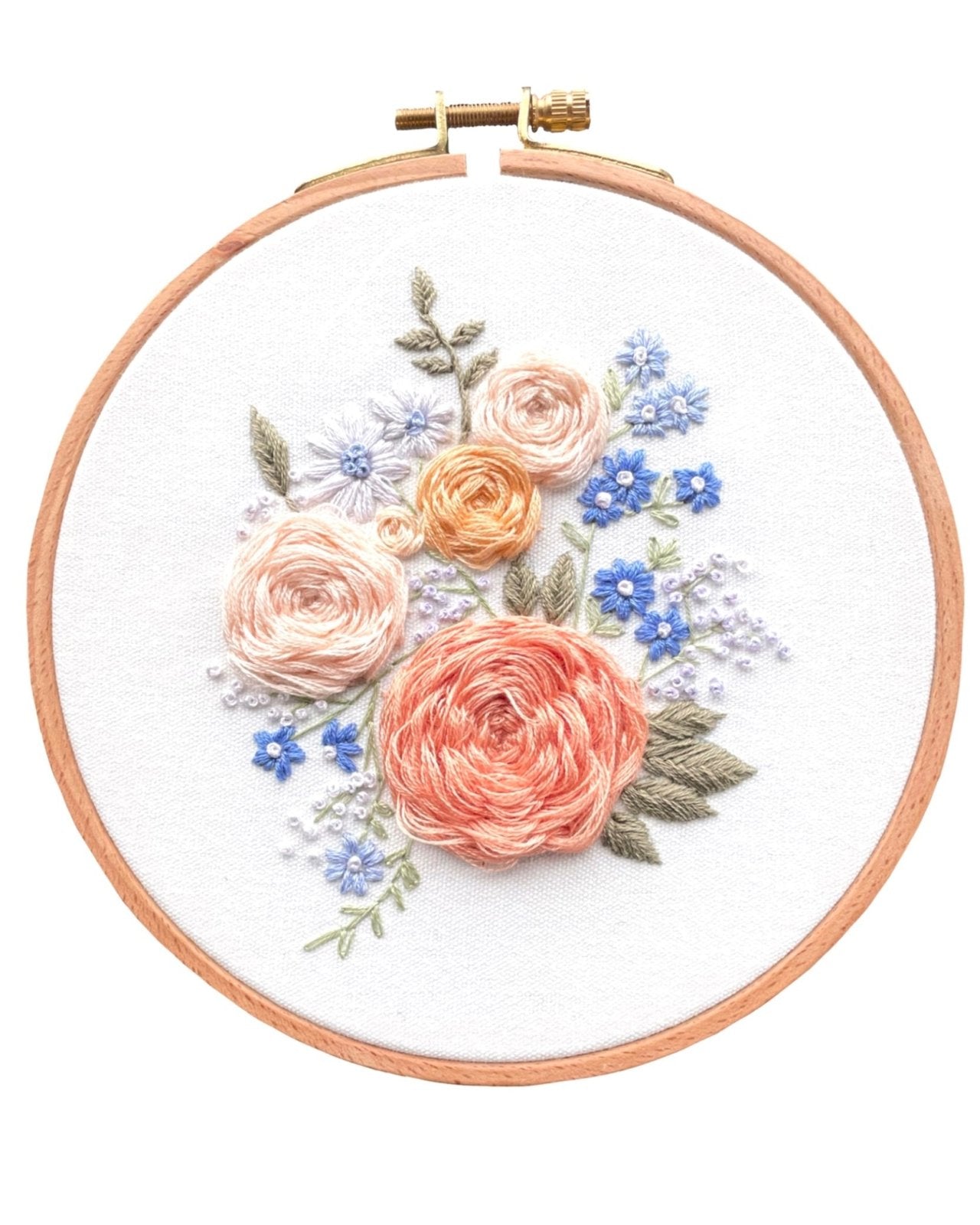 Completed floral embroidery kit on white background with a pink and purple colour palette 